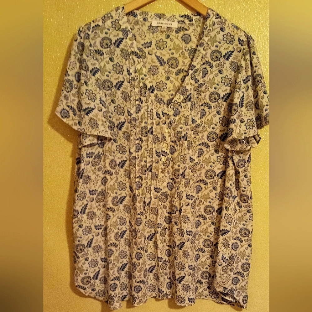 A Women's short sleeve blouse by Rose & Olive blue and cream in color.